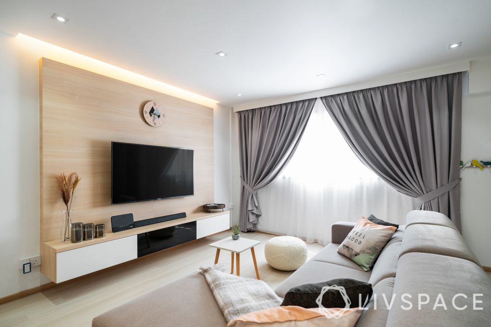 hdb-living-room-design-light-colours-grey-couch-wooden flooring-grey-drapes