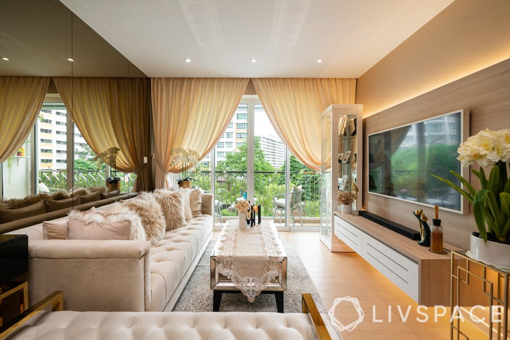 hdb-living-room-design-wall-mirrors-plush-sofa-wooden-flooring-coffee-table-display-cabinet