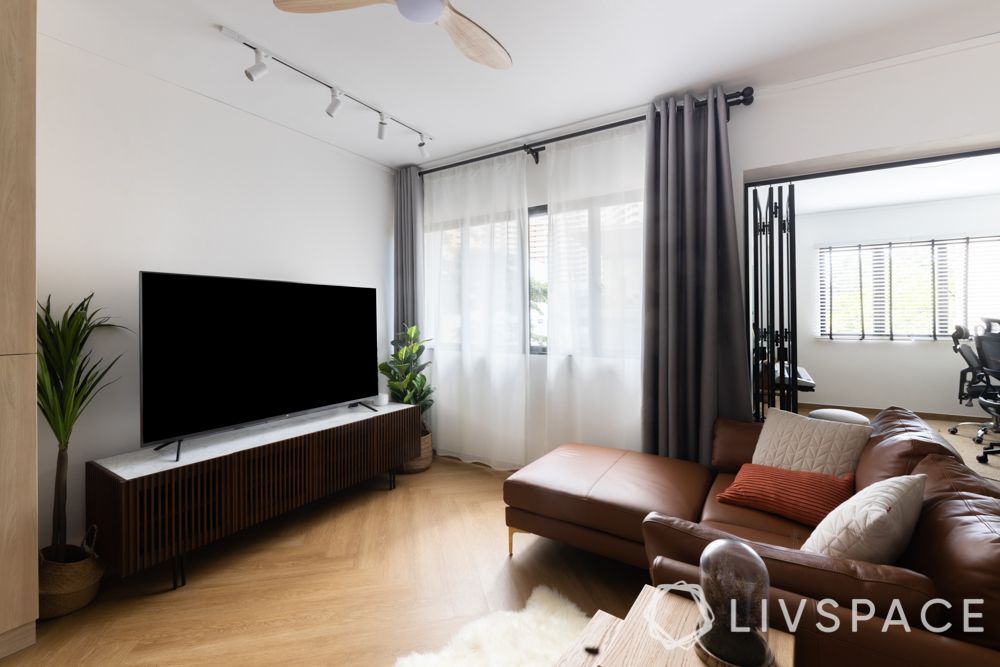 hdb-living-room-design-warm-brown-leather-sofa-wooden-flooring-dark-brown-TV-unit