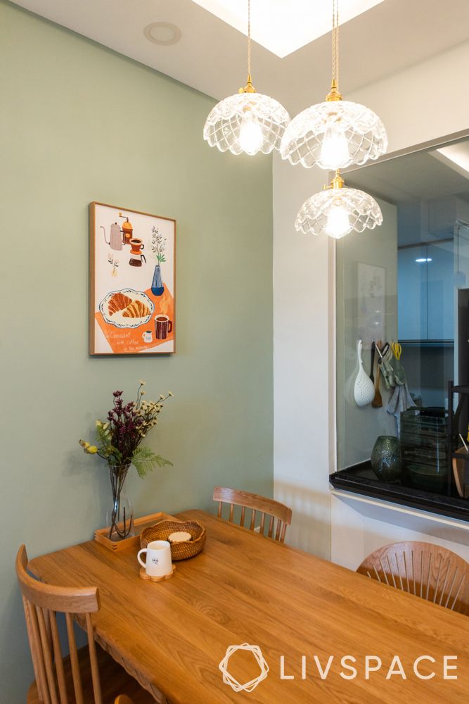 small-condo-design-ideasdining-room-green-wall-poster-pendant-light-wooden-furniture
