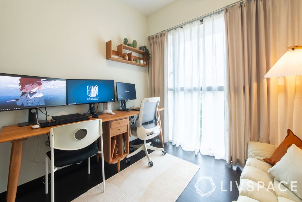 small-condo-design-ideas-study-beige-curtains-wooden-desk
A long table can fit in all the electronics and other work essentials