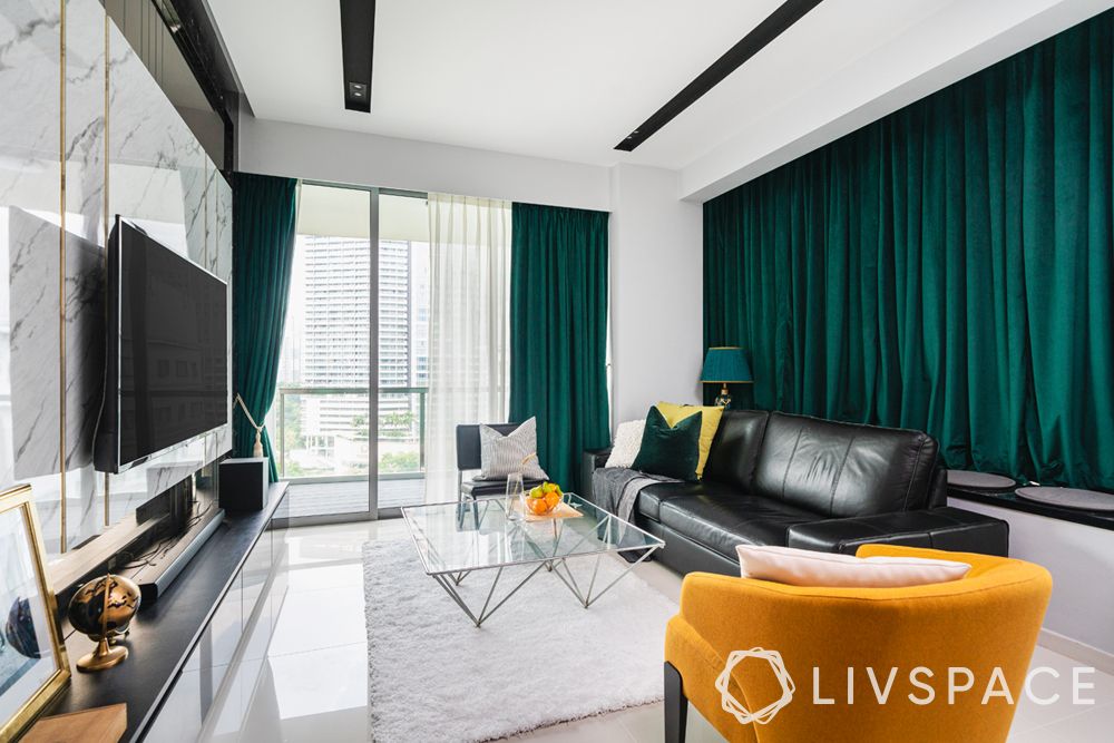 living-room-designer-mustard-chair-green-curtains