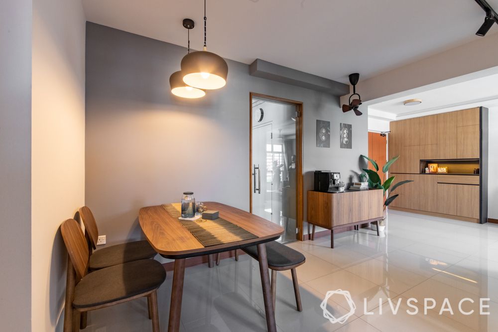 hdb-4-room-resale-renovation-dining-area-wooden-table-bench-chair-kitchen-grey-wall
