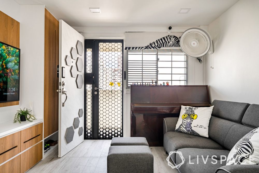 resale-3-room-HDB-design-entrance-grey-couch-honeycomb-panels-main-door-storage-unit