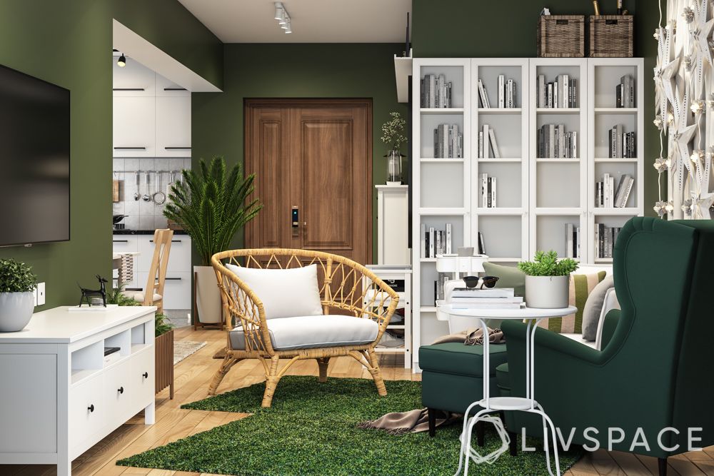 best-interior-design-singapore-living-room-green-walls-wing-chair-white-book-cabinet-bamboo-arm-chair
