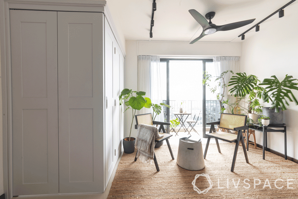 3-room-bto-renovation-living-room-white-bifold-door-plants-wooden-chairs