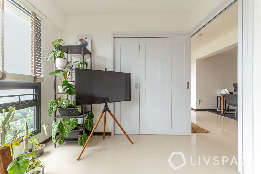 3-room-bto-renovation-living-area-tripod-TV-stand-bifold-door-plants