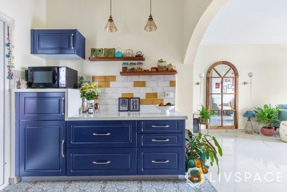 shaker-style-cabinets-blue-open-tiled-backsplash-white-countertop