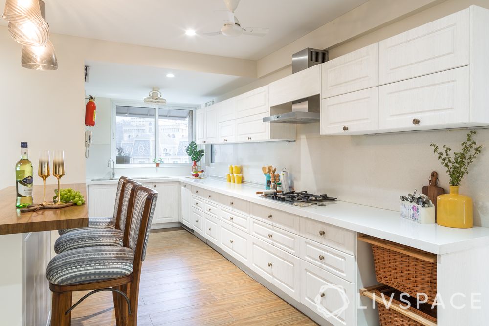 shaker-style-cabinets-white-traditional-carved-knobs-pendant-lights-breakfast-counter