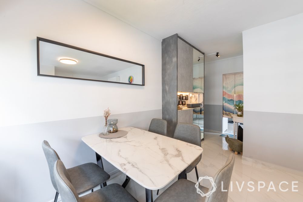 interior-decoration-marble-top-dining-table-mirror-grey-chair-tall-storage-unit