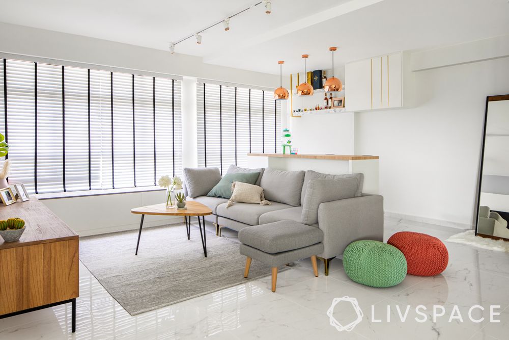small-house-design-ideas-living-room-white-walls-grey-sofa-rug-pouffes
