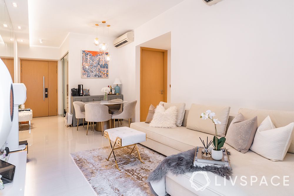 small-condo-interior-design-living-room-beige-sofa-l-shaped-white-stool-grey-rug