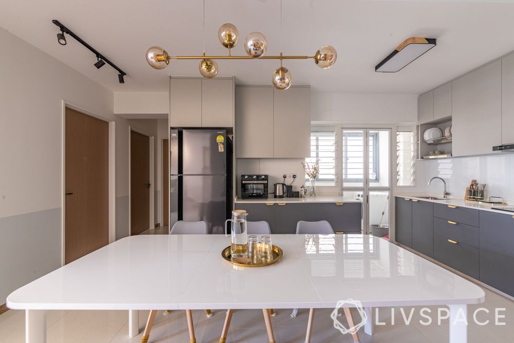 small-apartment-design-living-room-dining-table-white-chairs-metal-accents