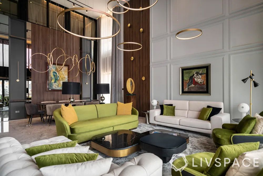 luxe-condo-interior-design-with-green-sofas-in-living-room-and-contemporary-chandeliers