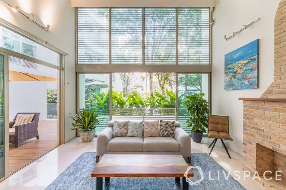 condo-interior-design-with-french-windows-fireplace-and-plants