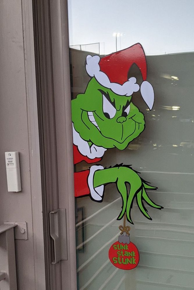 Grinch sticker on a glass door as a christmas decor idea